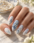 Blue Hour Veil hand-painted press-on nails — on an adult hand. Design preview.