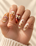 Cinnamon Lanterns hand-painted press-on nails shown on a hand