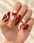 Midnight Ribbon hand-painted press-on nails shown on a hand