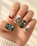 Winter Finch hand-painted press-on nails shown on a hand